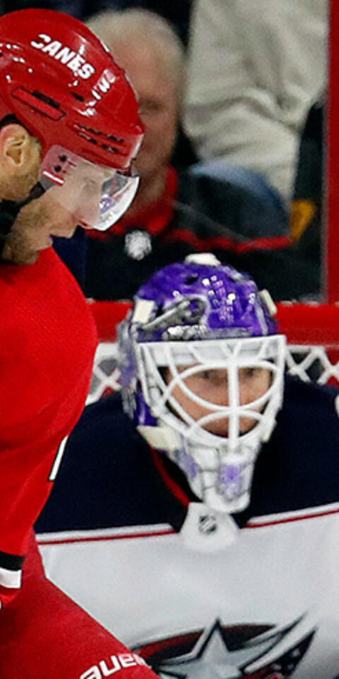 Carolina Hurricanes' Jordan Staal (11) has the puck go just past as he is defended by Columbus Blue Jackets' Pierre-Luc Dubois (18) during the first period of an NHL hockey game, Saturday, Nov. 17, 2018, in Raleigh, N.C.