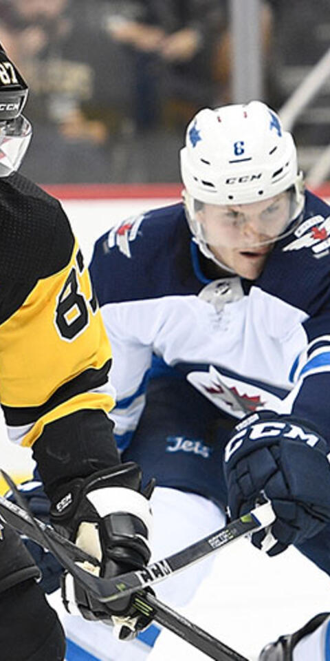 Sidney Crosby #87 of the Pittsburgh Penguins skates with the puck against Jacob Trouba #8 of the Winnipeg Jets during the game at PPG PAINTS Arena on October 26, 2017 in Pittsburgh, Pennsylvania.